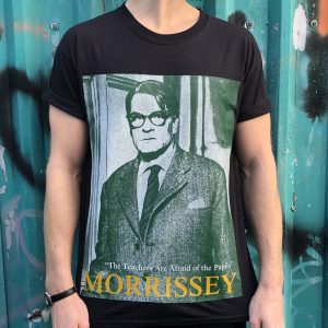 A black T-shit with a green-hue picture of Laurence Olivier playing a teacher in the film Term of Trial. Underneath are the words "the teachers are afraid of the pupils" in white and the word "Morrissey" in yellow