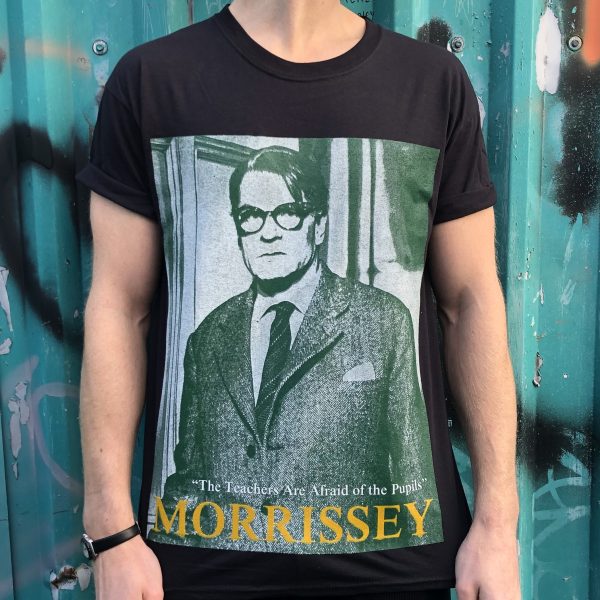 A black T-shit with a green-hue picture of Laurence Olivier playing a teacher in the film Term of Trial. Underneath are the words "the teachers are afraid of the pupils" in white and the word "Morrissey" in yellow